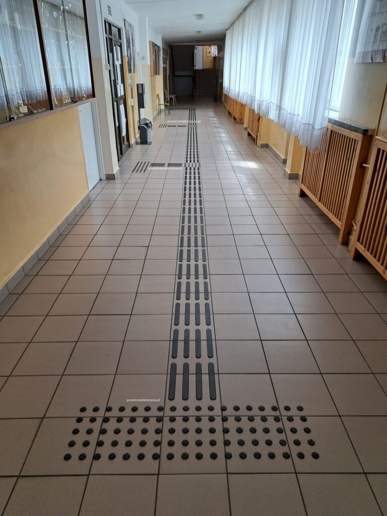 Ścieżka dotykowa z linią prowadzącą w korytarzu.